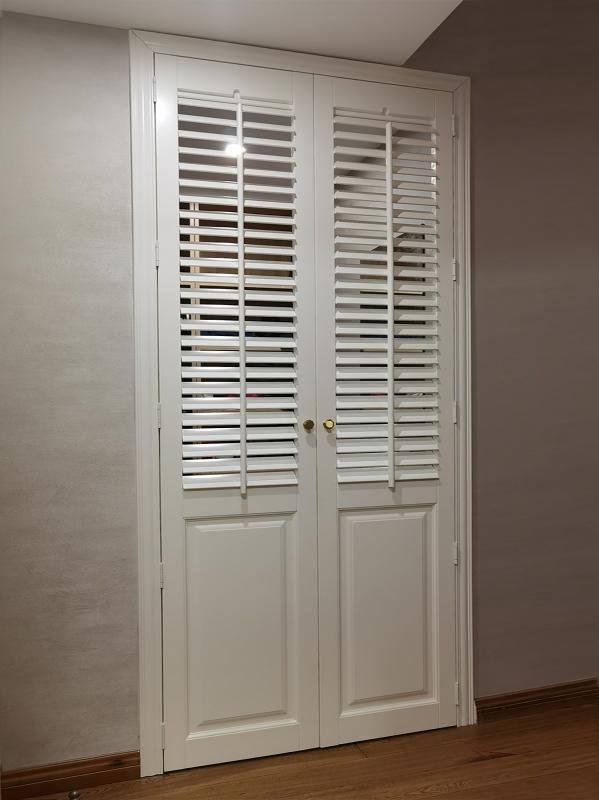 Raised half-solid plantation shutters for french doors