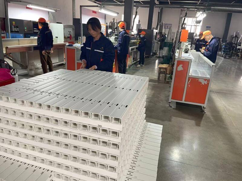 CNC precision cutting and punching of faux wood venetian blind slats at Bright Shutters