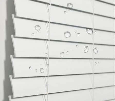 Close-up of faux wood venetian blind slats showing PVC wood grain texture -- 50mm slat width