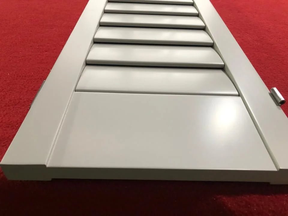 Plantation shutter close-up -- louvre detail, gear-rod mechanism and frame finish