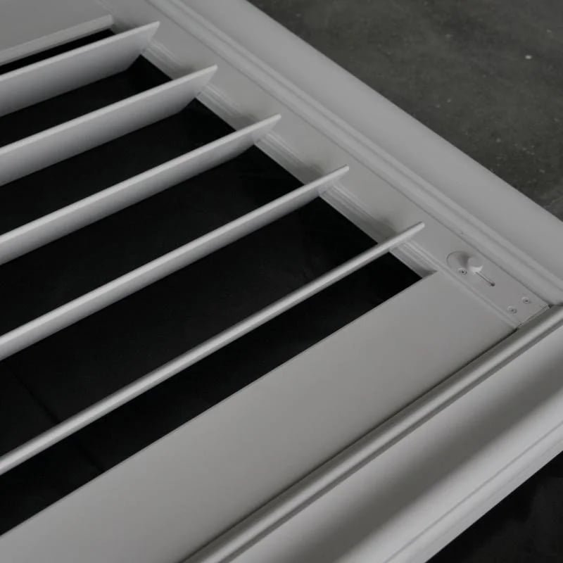 Aluminium plantation shutter close-up showing gear tilt rod and integrated rail design
