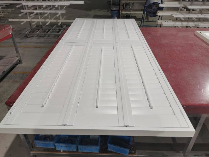 Bi-fold shutter track system with aluminium rail