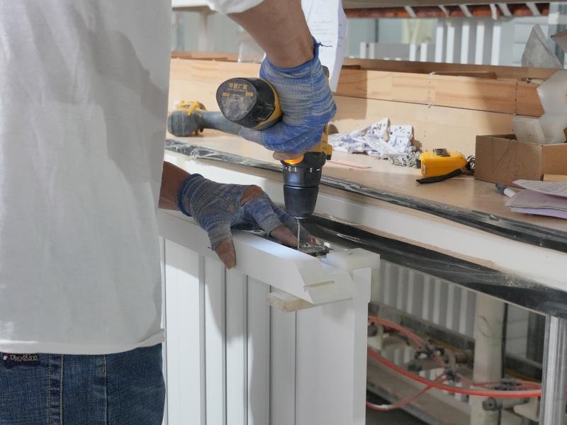 CNC drill stations creating precision holes and inserting stainless steel pivot pins